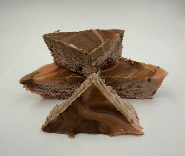 Chocolate amaretto fudge pieces stacked on a white background