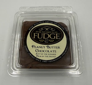 Peanut Butter Chocolate fudge in a clear plastic container on a white background