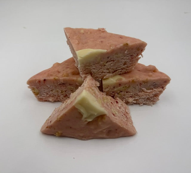 Vanilla fudge pieces with pink strawberry mash