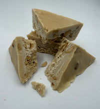 Vanilla caramel fudge with cashew nuts on a white background