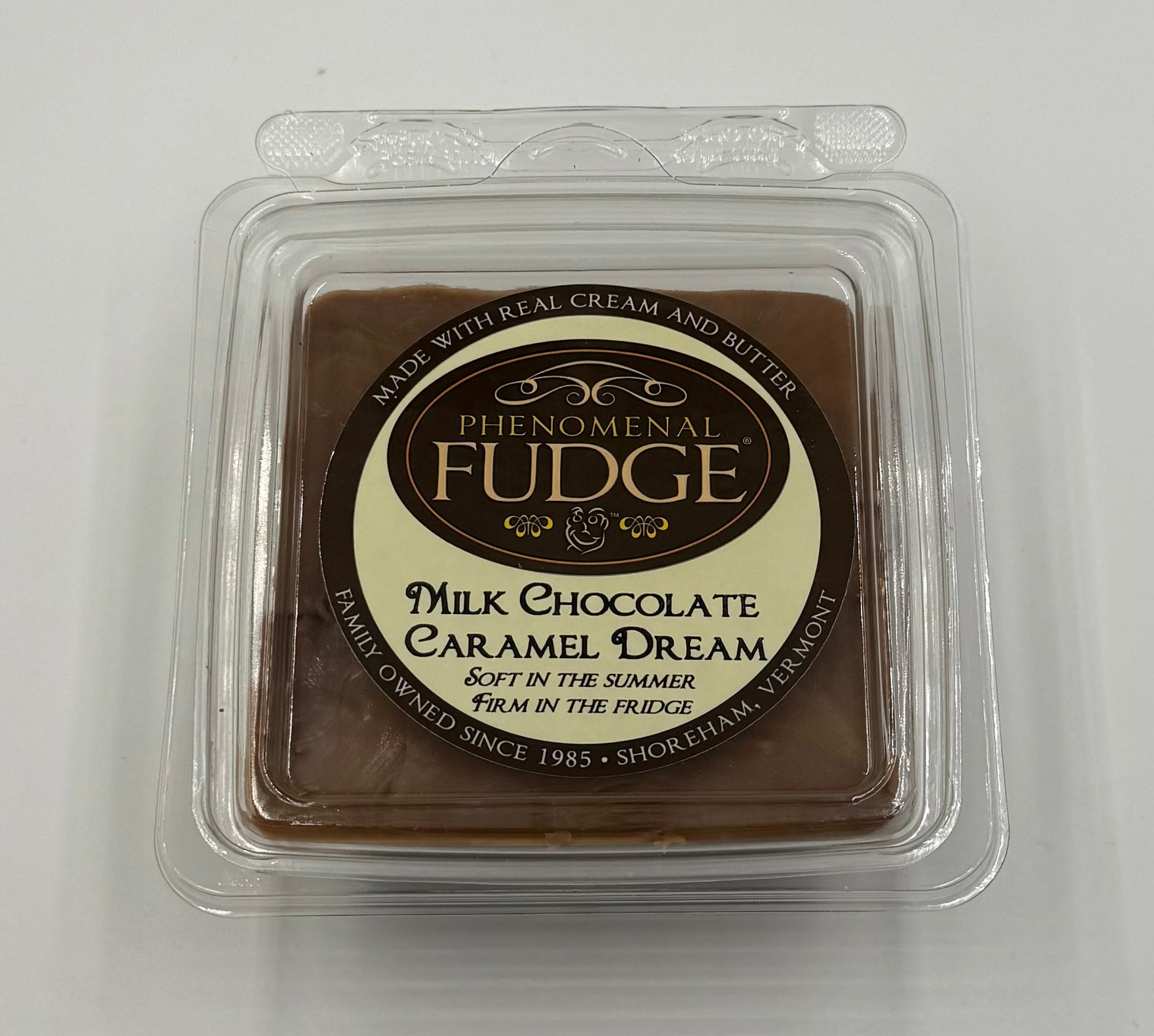 Milk chocolate fudge in a clear plastic packaging with 'Phenomenal Fudge' branding on a white background.