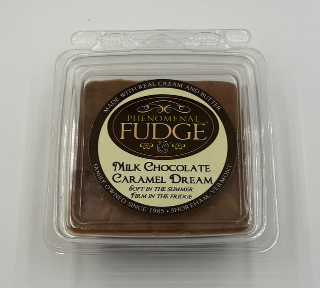 Packaged milk chocolate caramel fudge with peanuts on a white background
