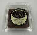 Peanut Butter Chocolate fudge in a clear plastic container on a white background