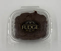 Chocolate fudge in a clear plastic clamshell container with a black and gold label reading 'Phenomenal Fudge'.