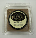 A square package labeled 'Phenomenal Fudge Spice Cake' in a clear plastic clamshell container on a plain light background.