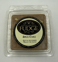 A square package labeled 'Phenomenal Fudge Spice Cake' in a clear plastic clamshell container on a plain light background.